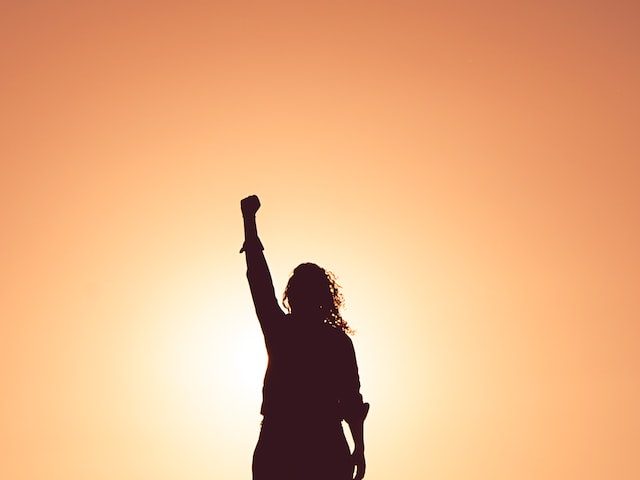 Still I Rise, woman with lifted fist