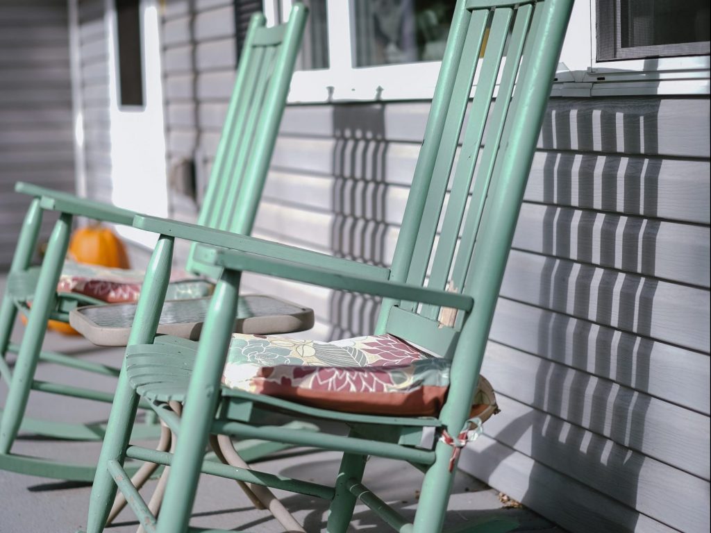 Rocking chairs on a porch in the sun