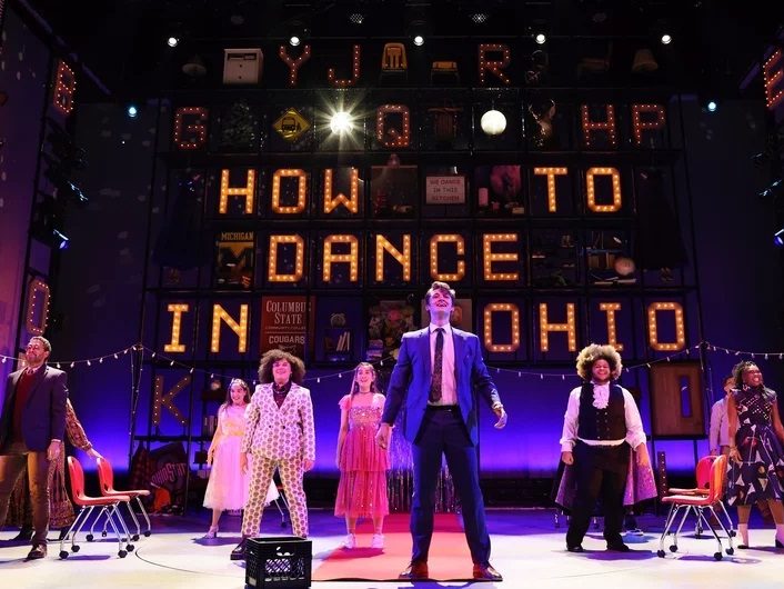 7 actors on stage in front of a sign of the musical's title "how to dance in Ohio"