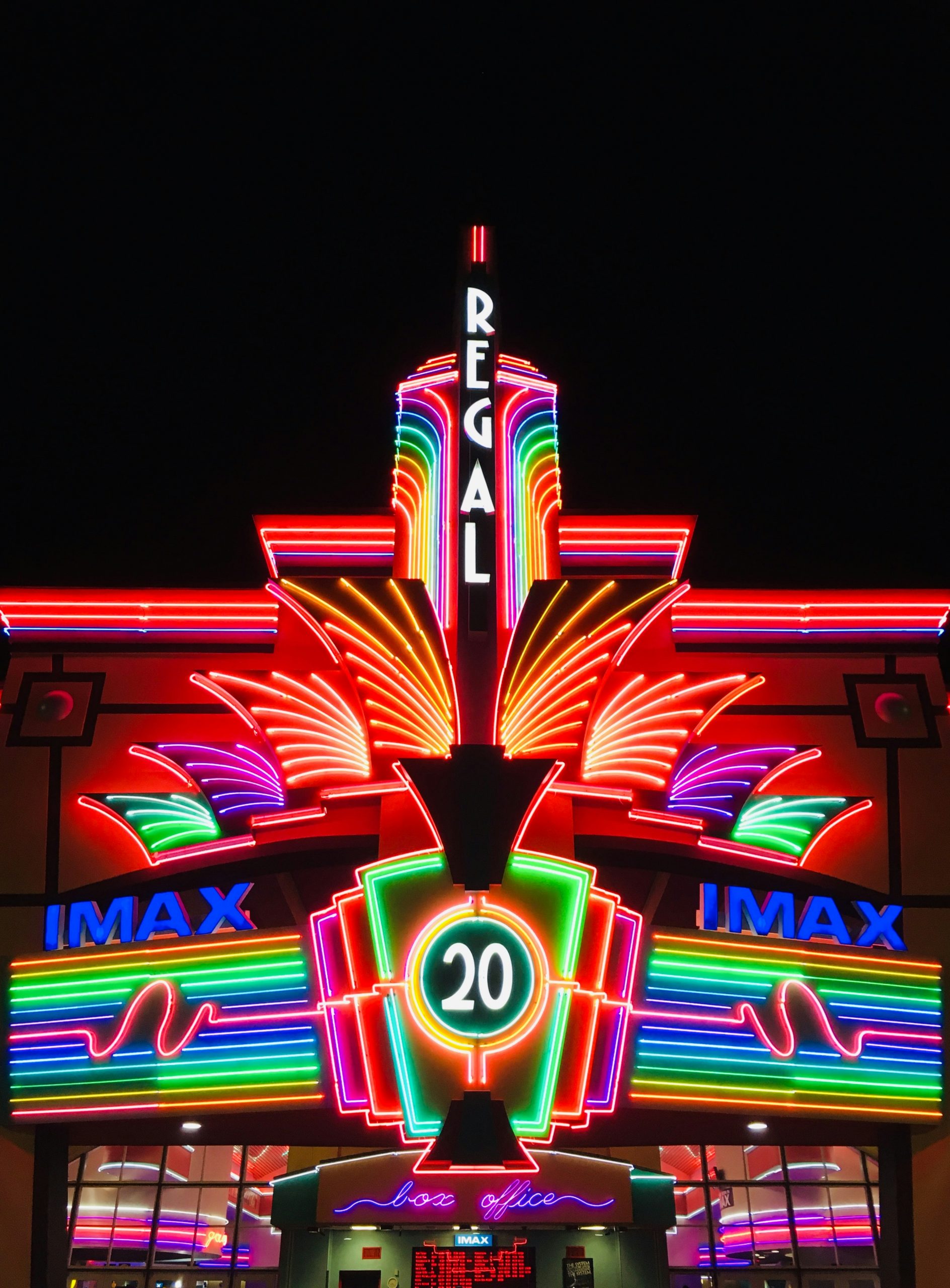 Colorful neon sign outside of a movie theater